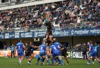 Exciting rugby match with crowds cheering at a stadium in Montpellier, Occitanie, France.