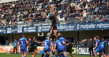 Exciting rugby match with crowds cheering at a stadium in Montpellier, Occitanie, France.