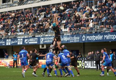 Exciting rugby match with crowds cheering at a stadium in Montpellier, Occitanie, France.