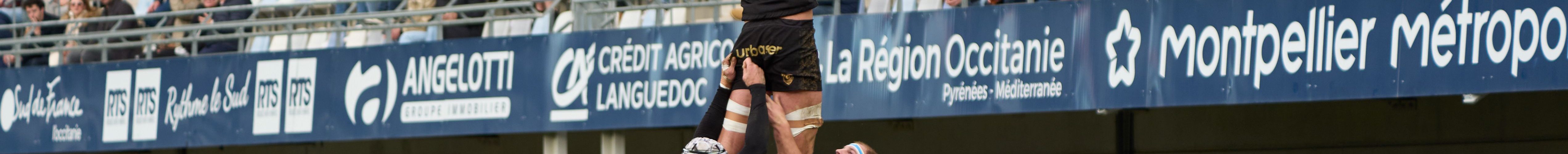 Exciting rugby match with crowds cheering at a stadium in Montpellier, Occitanie, France.